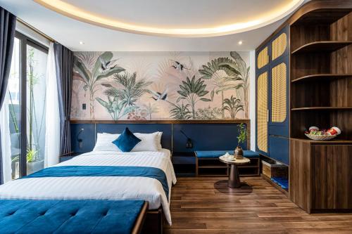 a bedroom with a blue and white bed and a wall mural at KunKin Garden Aparthotel in Ho Chi Minh City