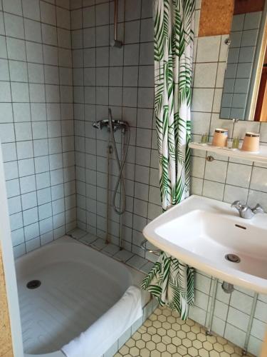 a bathroom with a tub and a sink at L'Auberge de Lugos in Lugos