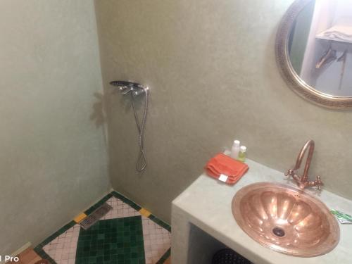 a bathroom with a sink and a mirror at Riad Dar Mchicha by phoenix in Marrakesh