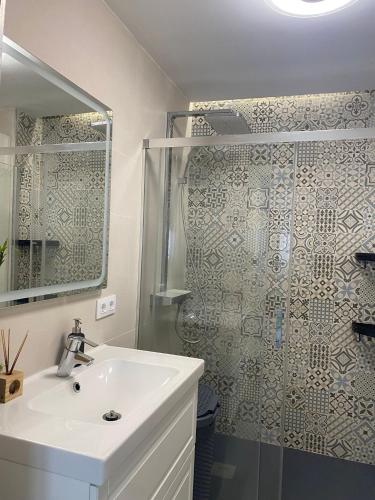 a bathroom with a shower and a white sink at Tarifabeach in Tarifa
