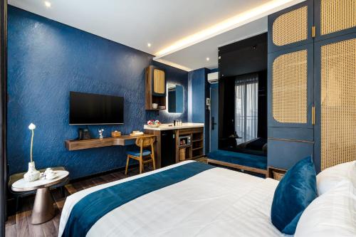 a hotel room with a bed and a desk at KunKin Garden Aparthotel in Ho Chi Minh City