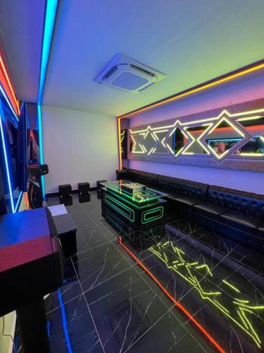 a room with a video game set up in a room at Dato Villa Luxury Homestay 12min to Jonker Street 26pax Private Pool Playground KTV BBQ in Melaka
