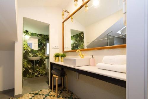a bathroom with a sink and a mirror at Sweet Surrender in Santander