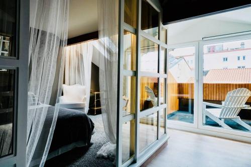 a bedroom with a bed and a sliding glass door at Sweet Surrender in Santander