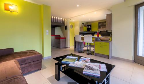 a living room with a couch and a table at Gîte des Pringets in Tresserves