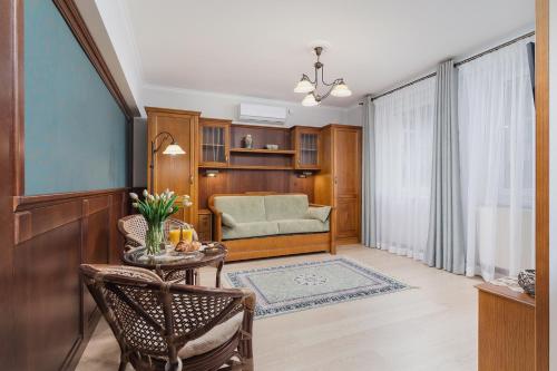 a living room with a couch and a table at Elegant Apartments in Krakow