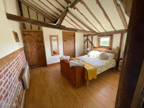 a bedroom with a bed in a room at The Cow Shed 2-Bed Apartment in Bradwell on Sea in Bradwell on Sea