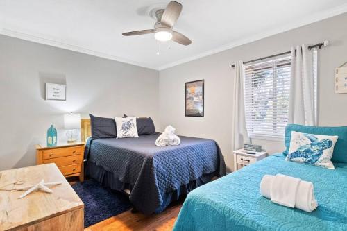 a bedroom with two beds and a ceiling fan at 5 MIN WALK TO BEACH- 2BR1BA Villa in The Dunes in Hilton Head Island