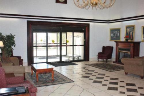 a living room with a couch and chairs and a table at ARK SUITES in Jonesboro