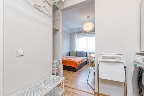 a room with a bed and a room with a washer and dryer at Prusu 17a in Rīga