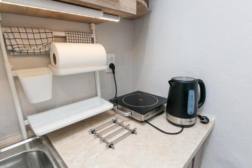 a kitchen counter with a coffee maker and a toaster at Prusu 17a in Rīga