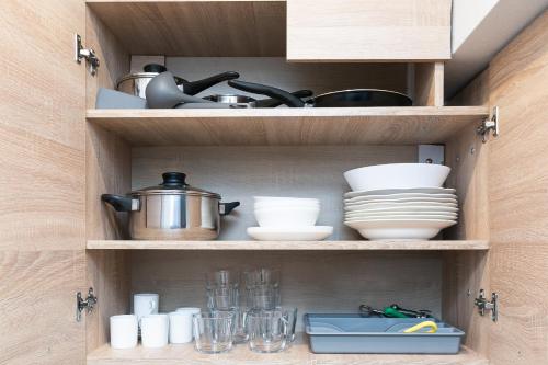 a cabinet filled with dishes and utensils at Prusu 17a in Rīga