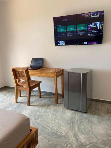 a room with a desk with a laptop and a chair at Bahía Santamaría in Moñitos