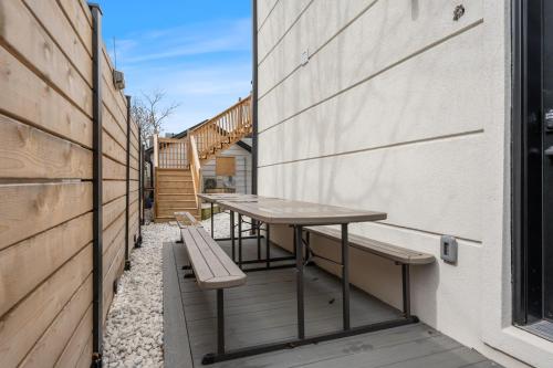 a table and benches on the side of a building at Luxe Lodges on Lake Erie in Port Dover