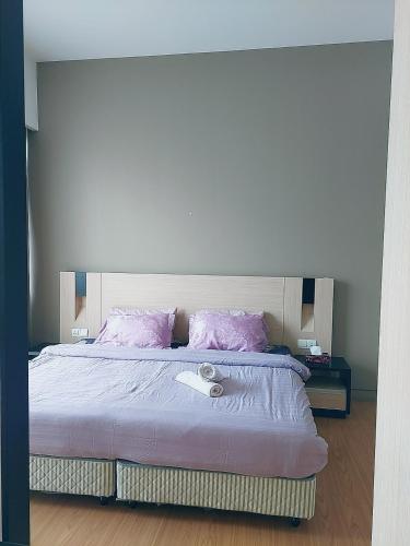 a bedroom with a bed with pink pillows at Swiss Garden Residence affordable stay in Kuala Lumpur