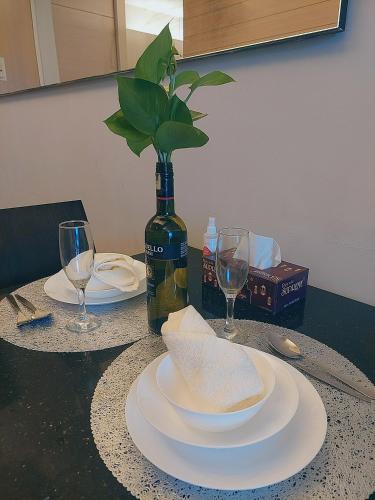 a table with two plates and a bottle of wine at Swiss Garden Residence affordable stay in Kuala Lumpur