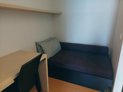 a small room with a blue bed and a desk at Swiss Garden Residence affordable stay in Kuala Lumpur
