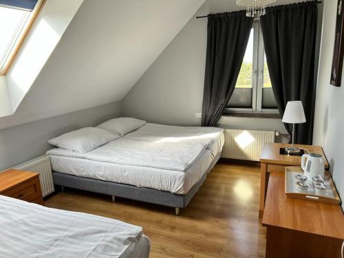 a small bedroom with two beds and a window at Pogodne Siedlisko Karpacz in Karpacz