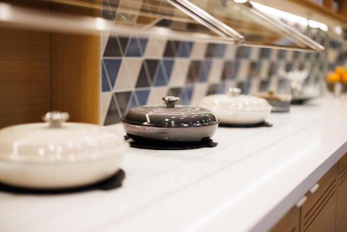 a counter with three bowls on a counter top at Hyatt Place San Carlos in San Carlos