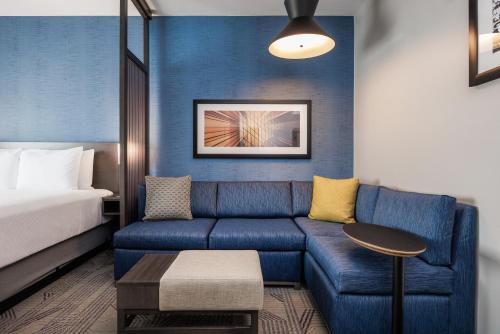 a hotel room with a couch and a bed at Hyatt Place San Carlos in San Carlos