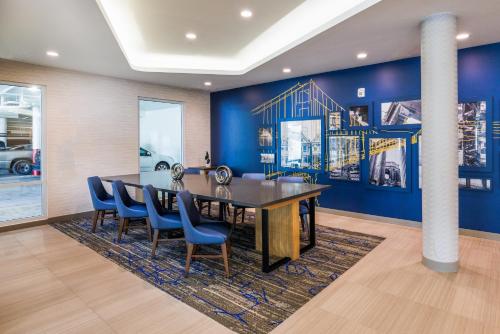 a dining room with blue walls and a table and chairs at Hyatt Place San Carlos in San Carlos