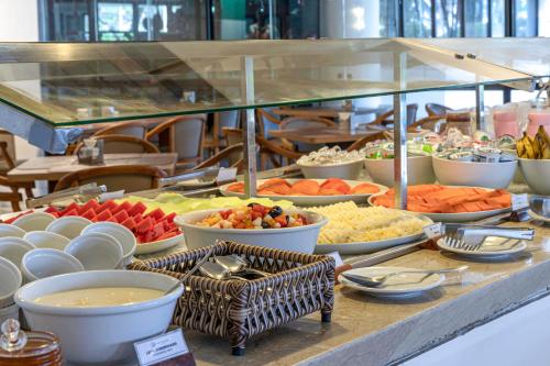 a buffet with many different types of food on a table at Maceió Atlantic Suites in Maceió