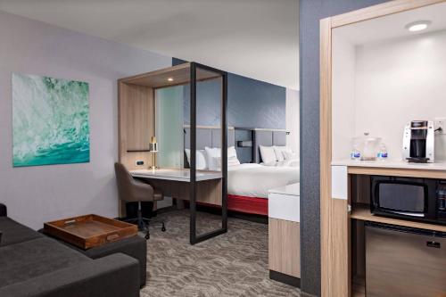 a hotel room with a bed and a desk at SpringHill Suites by Marriott Kansas City Plaza in Kansas City