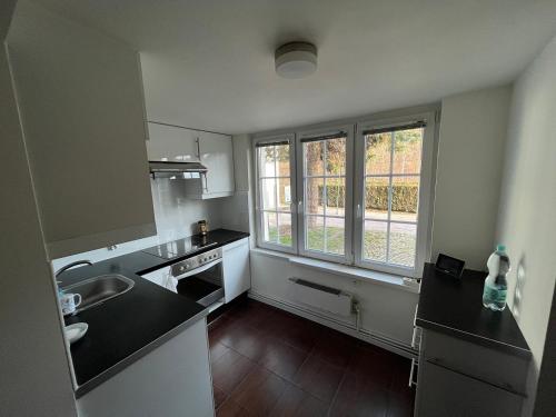 a small kitchen with a sink and a window at Zielone Wzgórze in Wałbrzych