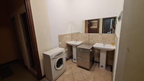 a bathroom with two sinks and a washing machine at Hotel Jan & in the very center in Yerevan