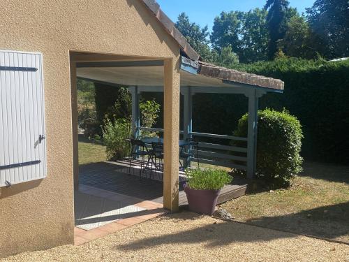 a pavilion with a table and chairs on a patio at Les Hauts Complex in Coulaures