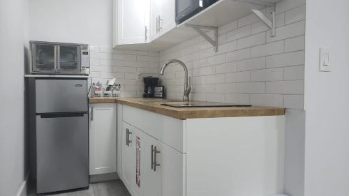 a kitchen with a refrigerator and a microwave at Funston in Hollywood