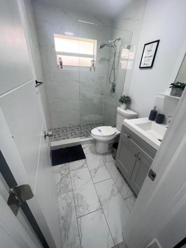 a bathroom with a shower and a toilet and a sink at Funston in Hollywood