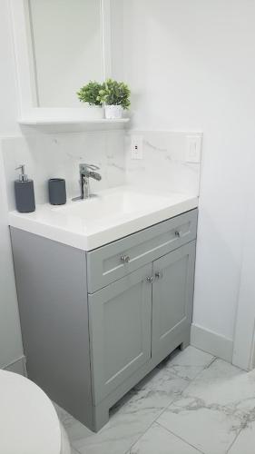 a white bathroom with a sink and a toilet at Funston in Hollywood