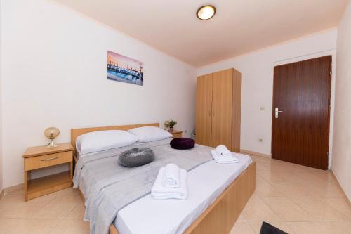 a bedroom with a bed with two pillows on it at Apartments Seaside in Bibinje