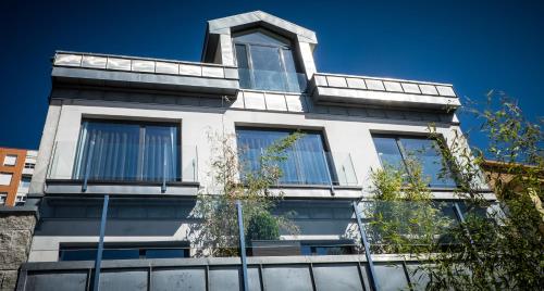 a white building with windows on top of it at Hotel Art Santander in Santander