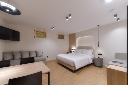 a hotel room with a bed and a couch at Zalo Urban Living Spaces in Ioannina