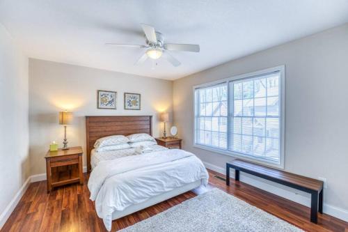a bedroom with a bed and a ceiling fan at Spacious Mountain House - 10 minutes from Asheville & Biltmore! in Asheville