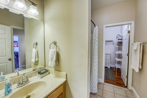 a bathroom with a sink and a mirror and a shower at Spacious Mountain House - 10 minutes from Asheville & Biltmore! in Asheville