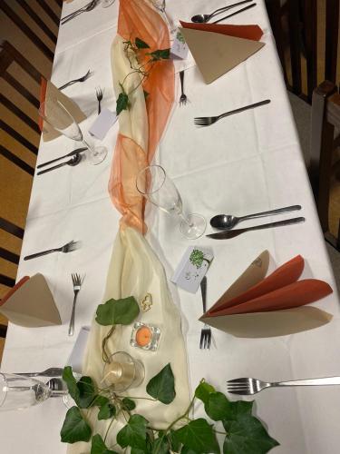 a table topped with a white table cloth with a table centerpiece at Glamping Challet Slunečno Český ráj in Dobšín