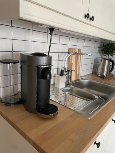 a coffee maker sitting on a counter next to a sink at Cosy, little apartment in Moss