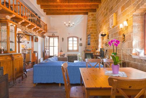 a living room with a table and a couch at VILLA VICTORIA OLD TOWN in Rhodes Town
