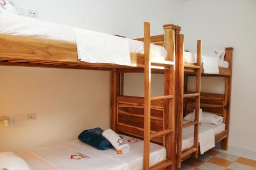 a bunk bed room with three bunk beds in it at Hostal Casa Torres Centro Historico - Adults Only in Cartagena de Indias