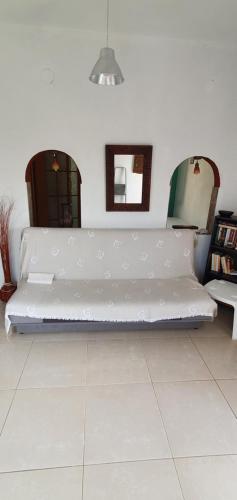a large white couch sitting in a room at The Cozy Yard in Nea Potidaea