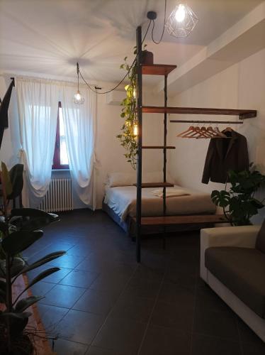 a bedroom with a bunk bed with blue curtains at glamhouse in Nizza Monferrato