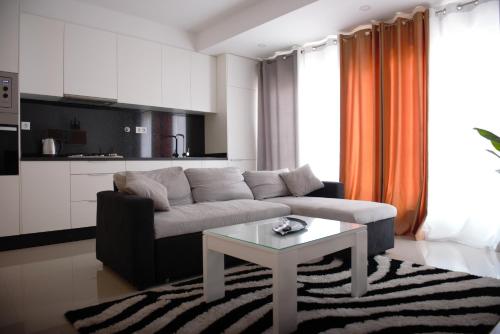 a living room with a couch and a table at Duarte Apartments - Morabeza in Mindelo