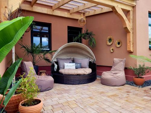 a patio with a bed in the back of a house at Pension Lavida Usedom in Zinnowitz