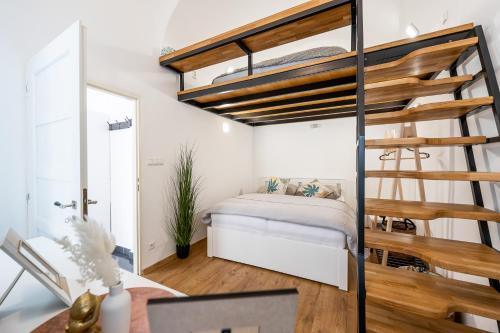 a bedroom with a bunk bed and a staircase at Hlavna Apartment Kosice in Košice