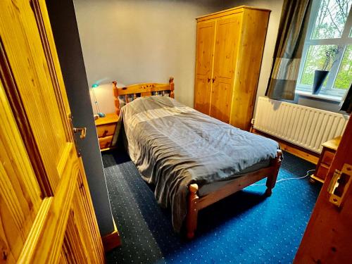 a small bedroom with a bed and a window at Muff 4 bed holiday rental in Muff