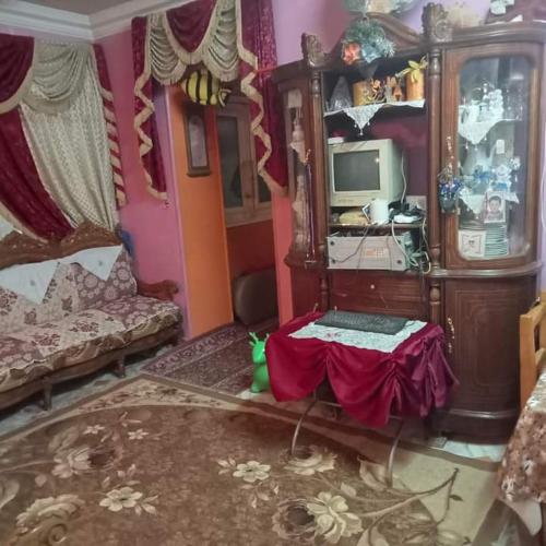 a living room with a tv and a couch at منزل مصطفى العوام 