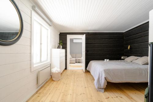 a bedroom with a white bed and a window at Kullanpuu's Farm Stay 